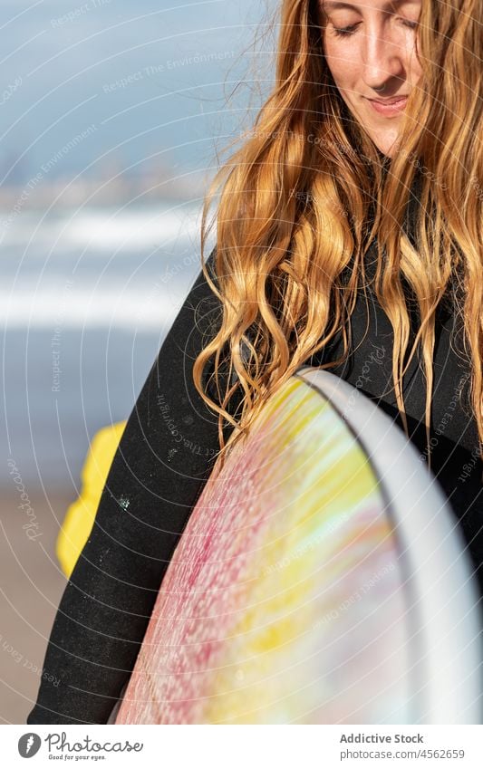 Woman portrait with surfboard in sea woman hobby activity pastime sport looking away water shore beach tide wave waterfront seaside nature equipment summer