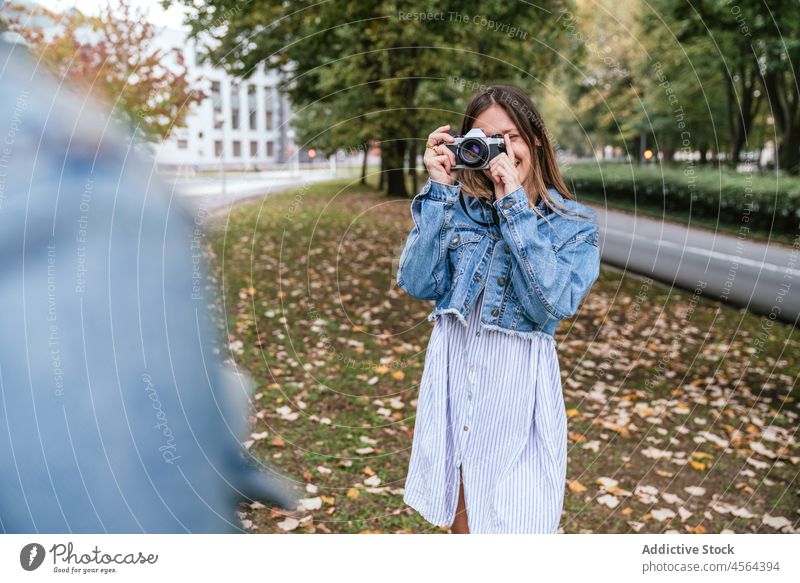 Anonymous woman taking photo of faceless friend take photo capture photo camera street spend time hobby photographer pastime photography city female friendship