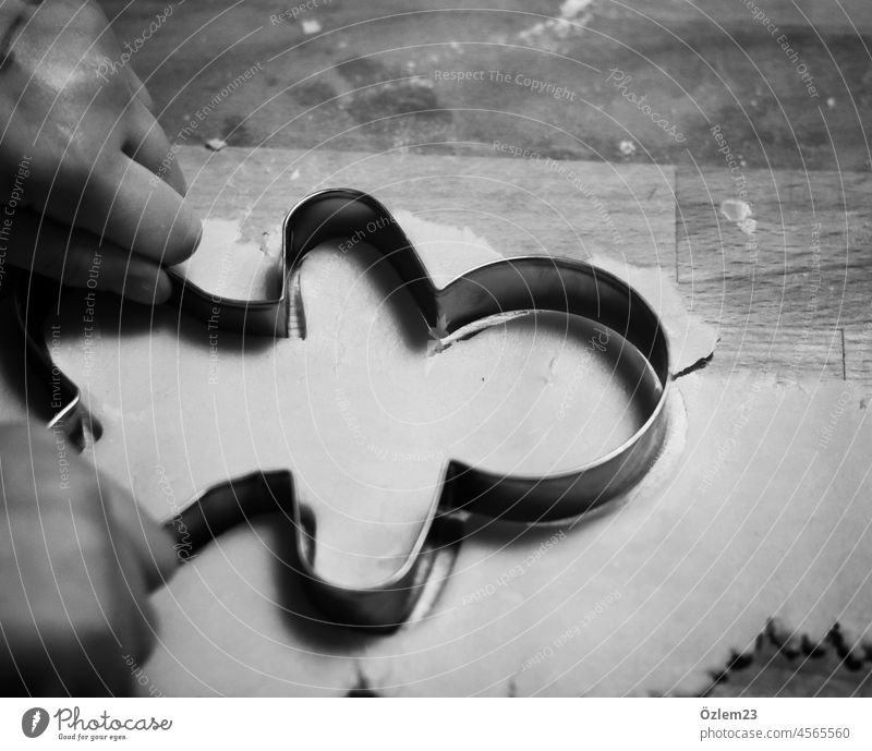 Cookie cutter cookie cutter Gingerbread man Black & white photo Interior shot hands dough Dough cut out cookies cookie dough bake cookies Christmas & Advent