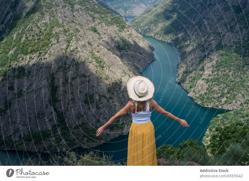 Young female traveler enjoying freedom in mountains over canyon woman admire ribeira sacra syl canyon galicia spain nature river edge landscape wanderlust