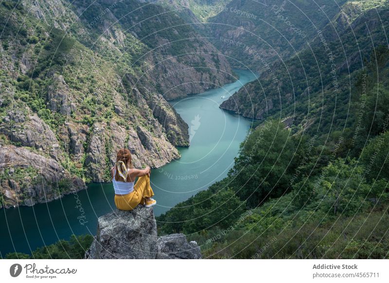 Young female traveler enjoying freedom in mountains over canyon woman admire ribeira sacra syl canyon galicia spain nature river edge landscape wanderlust