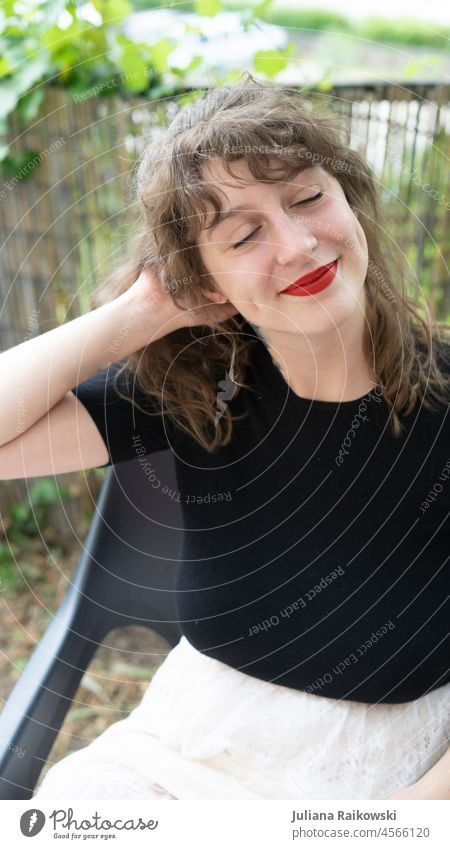 smiling woman sitting in garden Life Smiling Esthetic Emotions closeness to nature Happiness Happy Joie de vivre (Vitality) Contentment Closed eyes Optimism Joy