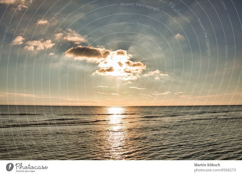 Sunset on the stand of Blåvand Denmark. Evening hours in warm light mood sunset sea beach wave vacation sand recreation dune north sea see travel baltic sea