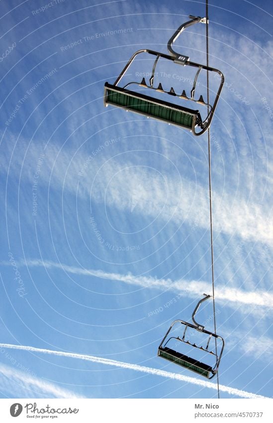 Chase race chair lift Winter Tourism Vacation & Travel Winter vacation Winter sports Ski lift Skiing Ski resort Chair lift Worm's-eye view Blue sky Hover