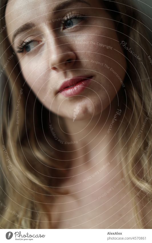 Very close portrait of a young blond woman with chin dimple - she looks dreamily out of the window Woman Young woman pretty Attractive Blonde long hairs