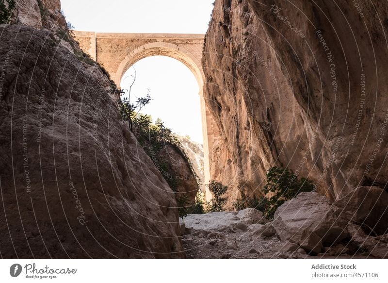 Historic bridges in nature of Calpe construction aged shabby historic mountain stone arched passage rocky old spain calpe mascarat sunlight environment scenery