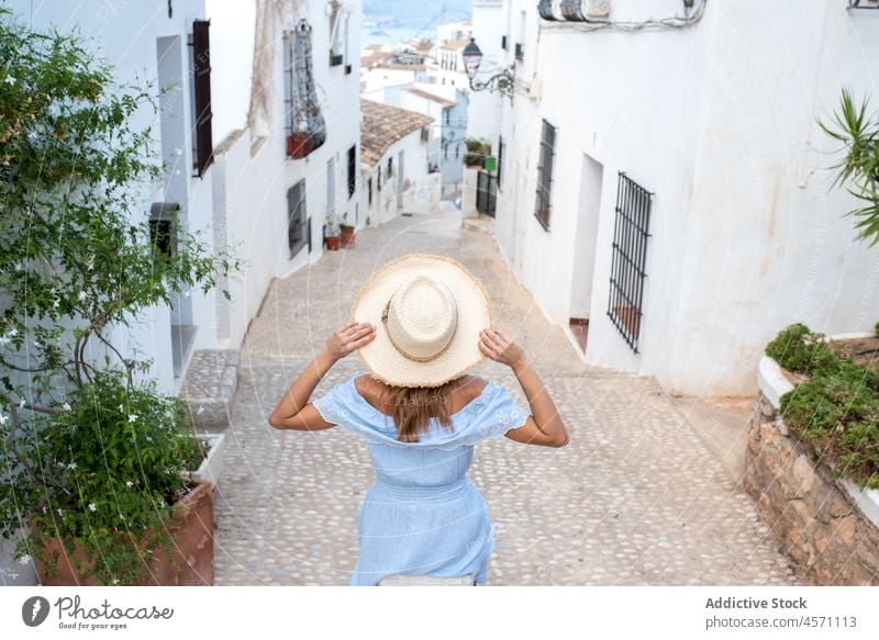 Anonymous woman on street of old coastal town in Altea traveler building house recreation footpath journey adventure summer environment spain location landmark