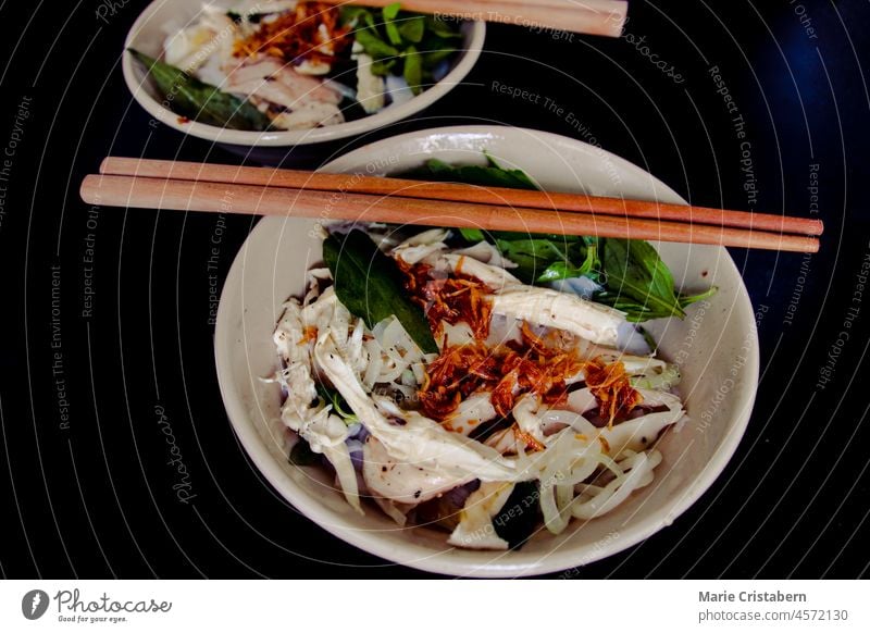 Banh Uot Long Ga, unique vietnamese dry rice noodles (flat and wide like wet rice cake noodle) dish mixed with herbs and meat, a local delicacy of Da lat Vietnam