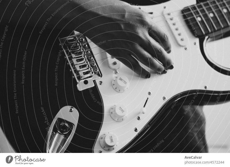 Close up of a pair of hands playing a guitar outdoors. Sunny day and practicing an instrument concept. Copy space music life on tour and nature. artist band