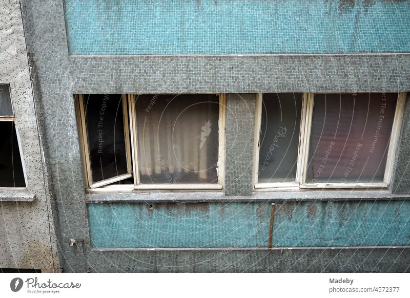 Dilapidated and dirty plain and businesslike facade of a commercial building with open window in the alleys of the old town of Taksim in the Beyoglu district of Istanbul on the Bosporus in Turkey