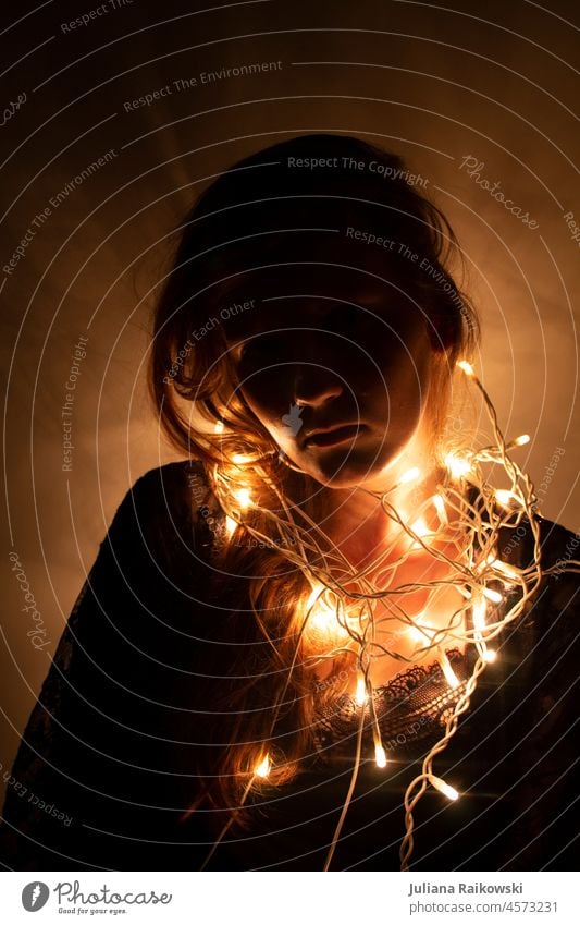 Woman with fairy lights around her neck Human being pretty romantic feminine clearer Bright Incandescent Glow Feasts & Celebrations Christmas Fairy lights