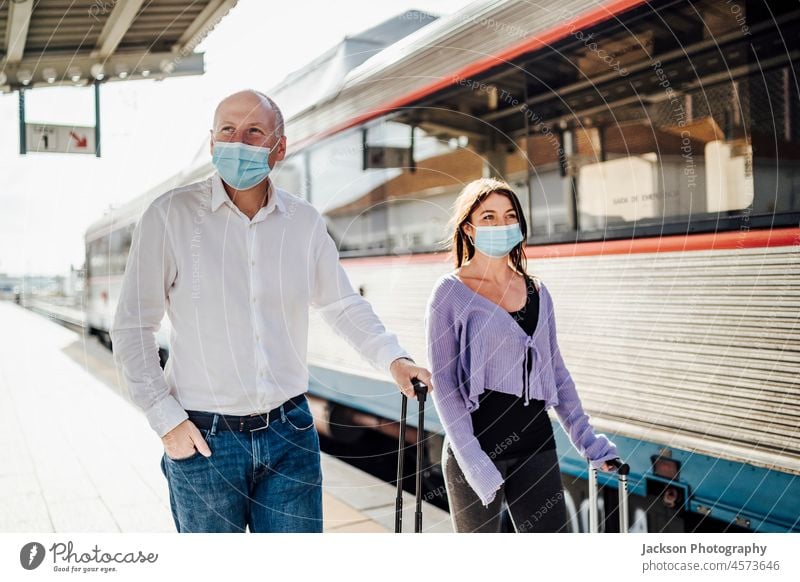 Tourists with suitcases and masks on the platform next to the train tourist portugal british new walk leave tourist guide traveler destination tourists outdoors