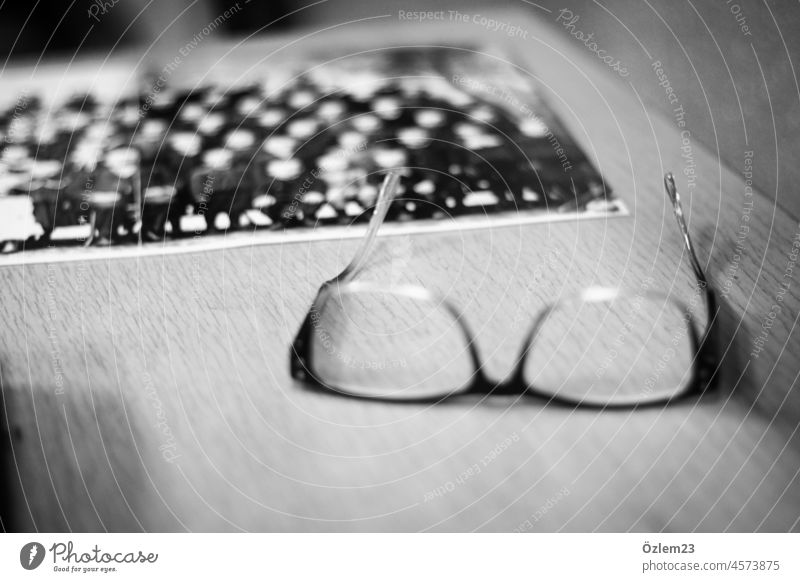 Glasses and an old class photo on the table Eyeglasses classroom Class Black & white photo Table Classroom School Girl Woman Education Study Room Infancy