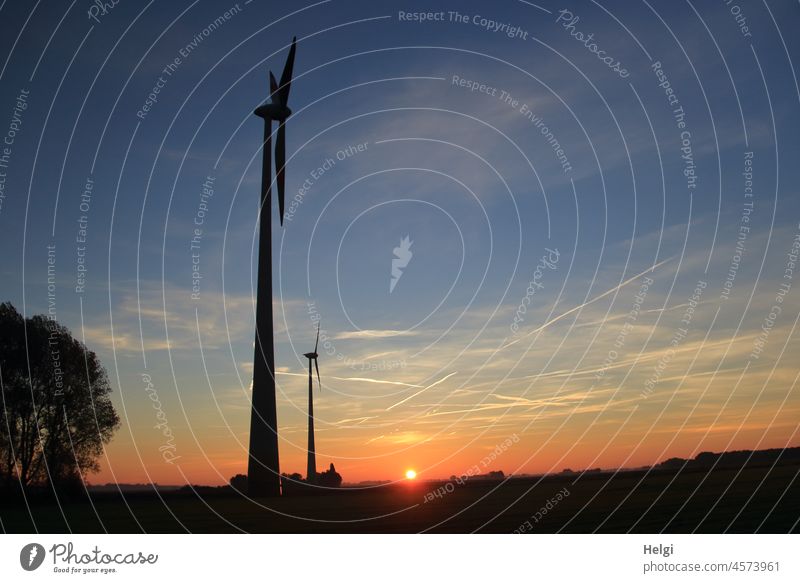 Sunrise - two wind turbines standing on a field in front of rising sun Pinwheel Wind energy plant Morning in the morning early Sunlight Light Shadow Landscape