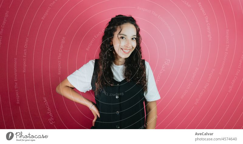 Young african woman happy looking at camera portrait. Removable background. Trendy styling. Close-up portrait of her she nice-looking attractive lovely vibrant pink color background