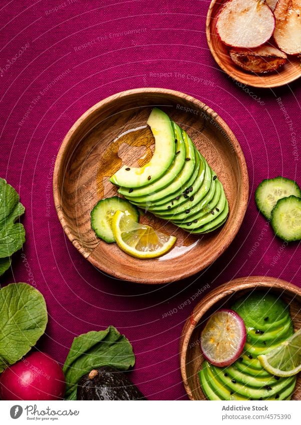 Assorted ingredients for dish cucumbers avocado radish and lime vegetable food slice chia seed assorted organic fresh meal fruit healthy cut arrangement