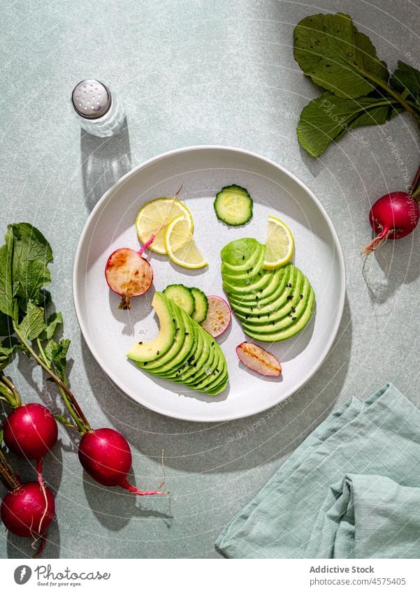 Assorted ingredients for dish cucumbers avocado radish and lime vegetable food slice chia seed assorted organic fresh meal fruit healthy cut arrangement