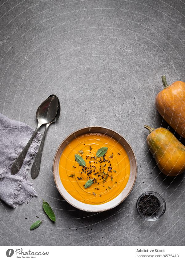 Tasty pumpkin soup placed on gray table bowl delicious vegetable gourmet tasty cuisine food yummy spoon serve healthy food nutrition restaurant seasoning