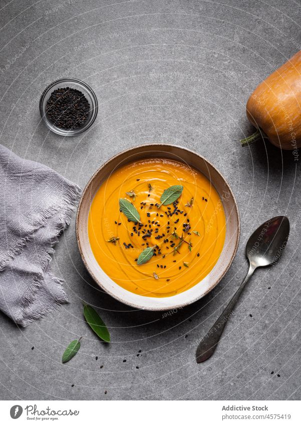 Tasty pumpkin soup placed on gray table bowl delicious vegetable gourmet tasty cuisine food yummy spoon serve healthy food nutrition restaurant seasoning