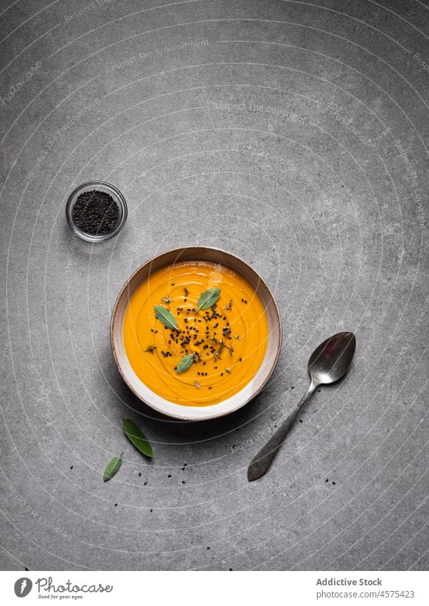 Tasty pumpkin soup placed on gray table bowl delicious vegetable gourmet tasty cuisine food yummy spoon serve healthy food nutrition restaurant seasoning