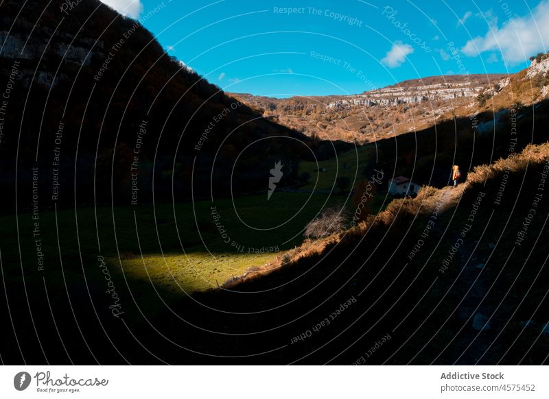 Hiker on footpath in mountainous area landscape hiker tourist travel nature trekking explore shadow autumn trip wanderlust adventure spain meadow cantabria sky