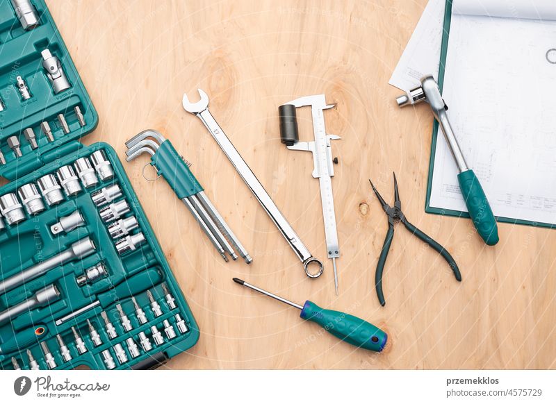 Workshop table with many tools. Wrench, spanner, calliper and ratchet with many attachments. Work tools. Universal tool set. Professional equipment repair