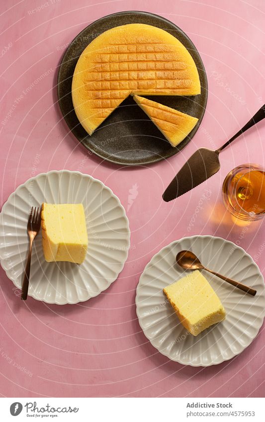 Tasty Japanese cheesecake served on plates whole cake japanese cheese cake dessert portion food pastry dish colorful bright spatula fork cotton palatable piece