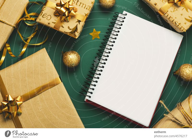 Merry Christmas. top view of notebook with christmas gifts and christmas decorations.christmas concept background Christmas presents christmas eve celebration