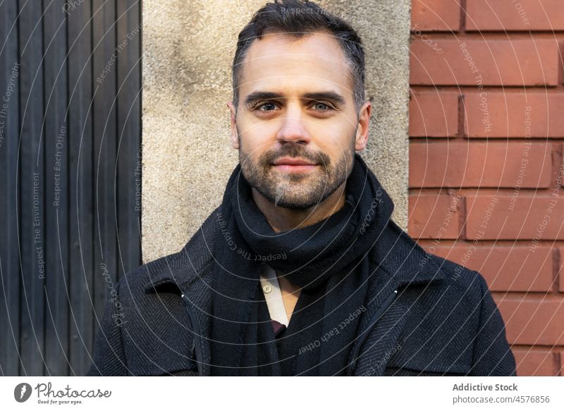 Serious male looking away against building in daytime man serious street calm coat city urban exterior pensive construction structure casual guy stand town