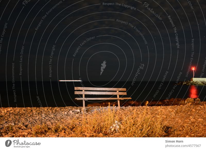 Bank by the sea at night coast Night position light Beach Ocean Horizon Night sky Park bench Far-off places Long exposure Strip of light waiting time