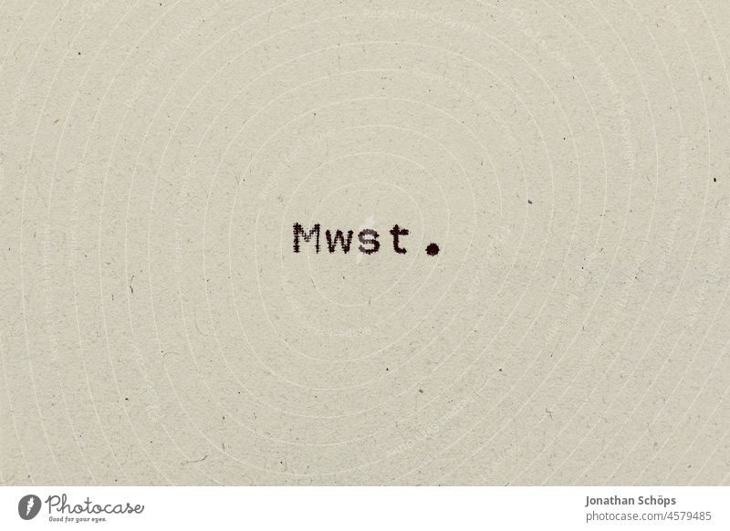 VAT as text on paper with typewriter value added tax mwst. Paper Percent Recycling Typewriter writing sinking typography Value added tax number Analog cheaper