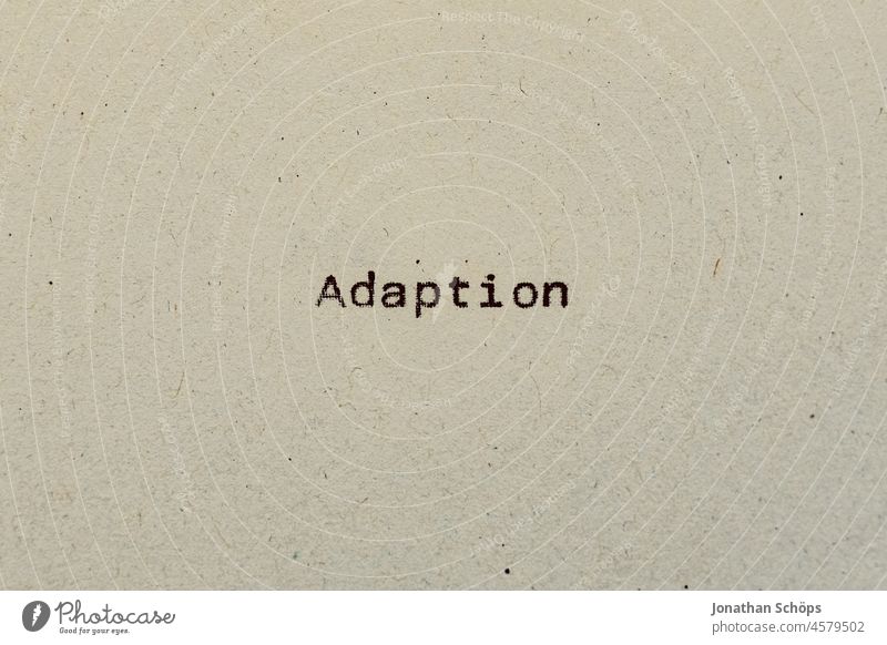 Adaptation as text on paper with typewriter adaptation Adjustment corona corona crisis coronavirus covid-19 Paper Recycling Typewriter writing typography Analog