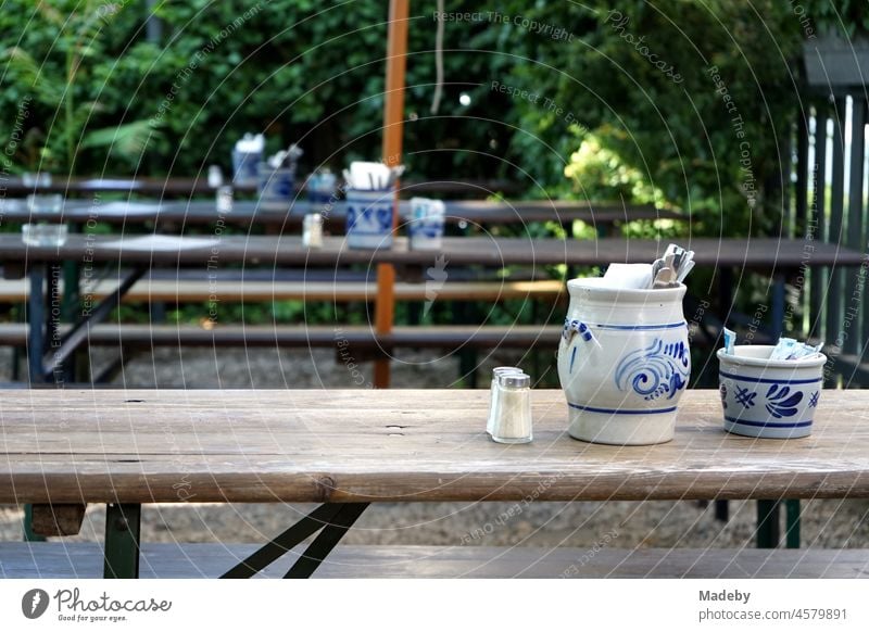 Typical traditional apple wine tavern with wooden tables and benches in the garden in summer at the Darmstädter Landstraße in the district Sachsenhausen in Frankfurt am Main in Hesse