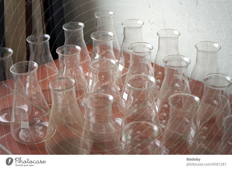 Old glass flasks and laboratory glassware from the chemical industry in an old factory hall with antiques in the Margaretenhütte district of Gießen on the Lahn in Hesse