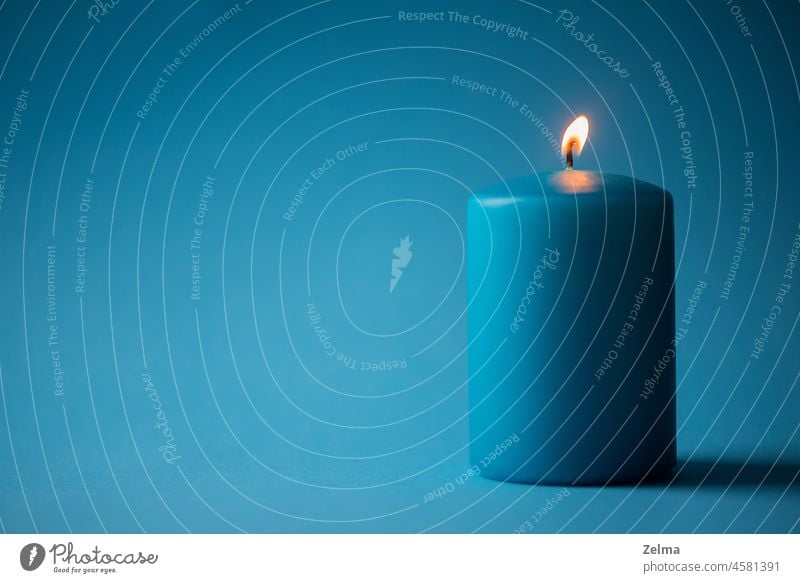 Blue burning candle isolated on blue background Candle Candlelight Burn Isolated Image minimalism Fire Flame Burning candle