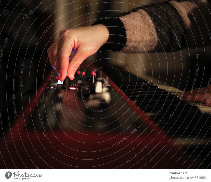 Girl playing red keyboard at night, hand on controller Hand hands Keyboard songwriting fumble Red Buttons Controller Music Playing play music Musical instrument