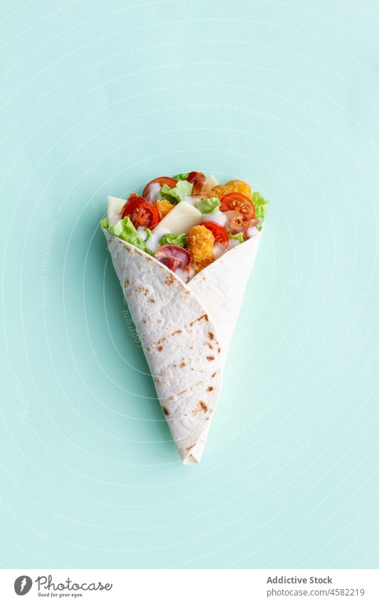 Chicken wrap with tomatoes and cheese chicken tortilla food lettuce snack meal fast food tasty delicious fresh vegetable nutrition colorful appetizing product