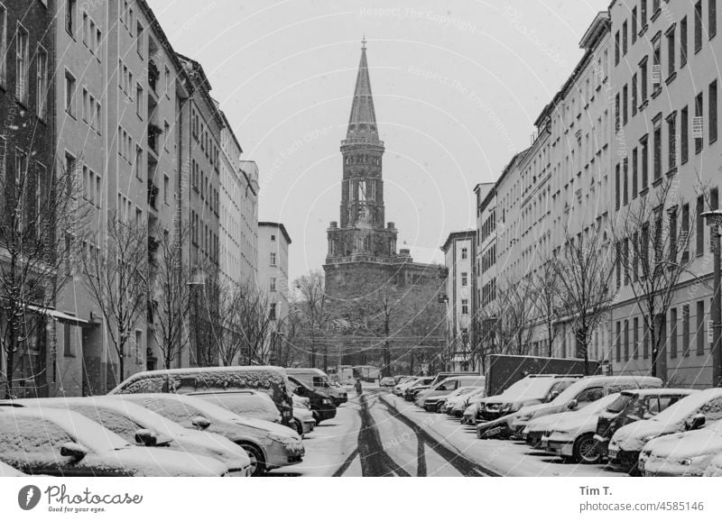 View through the street to the Zion Church Prenzlauer Berg Winter Snow Street b/w bnw Deserted Day Black & white photo Exterior shot Berlin Capital city