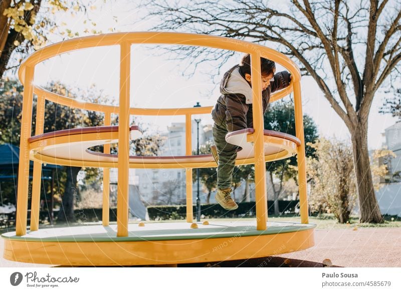 Child playing on playground childhood Boy (child) Playing Playful Playground playground equipment Life Day Park Kindergarten Leisure and hobbies Infancy Joy