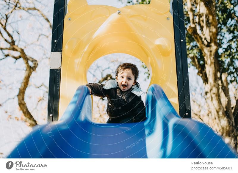 Child playing in the playground childhood 1 - 3 years Boy (child) Caucasian having fun Playing Playground Authentic playground equipment Slide Multicoloured