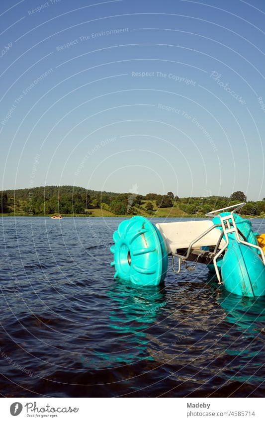 Water tricycle in bright turquoise in summer sunshine on the shore of Poyrazlar Gölü near Adapazari in Sakarya province, Turkey Aquatics Turquoise plastic