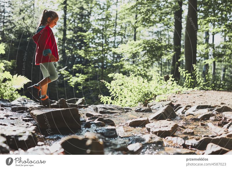 Little girl walking in mountains, spending summer vacation close to nature adventure trip travel hiking child kid trekking active backpack journey wanderlust