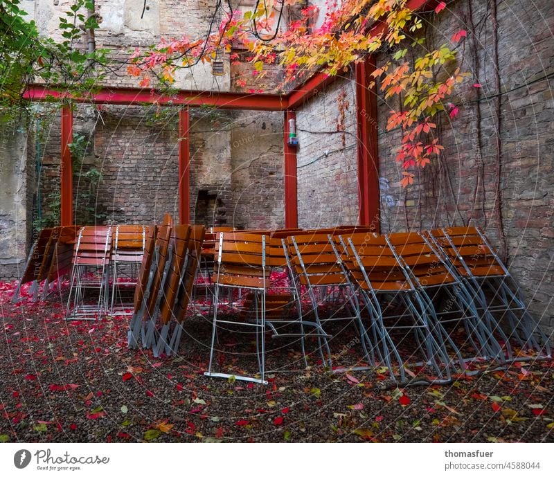 Closed garden restaurant, beer garden, in autumn, Corona Restaurant outside gastronomy Beer garden Garden chairs house wall Autumn leaves Empty Deserted Tourism