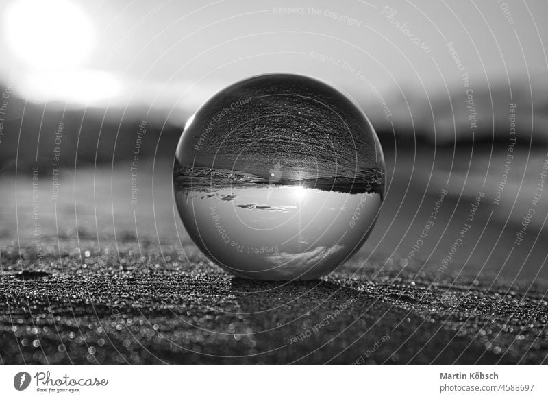 Glass globe on the beach of the Baltic Sea in Zingst in which the landscape is depicted Glass ball water baltic sea emotion horizon lightness sunset light mood