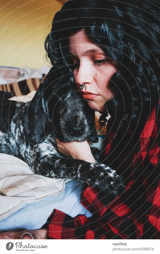 Cute shot of a young woman spending time with her dog pet love family care adorable loving home together togetherness brunette cocker cocker spaniel animal