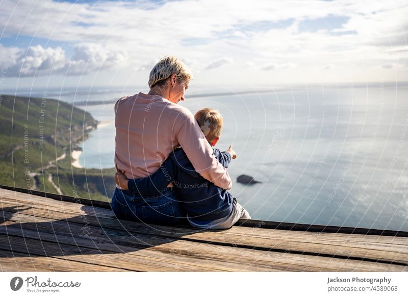 Mother and 3 years old son hugging each other and enjoying the beautiful ocean views kid mother nature boy child happy parent family childhood together woman