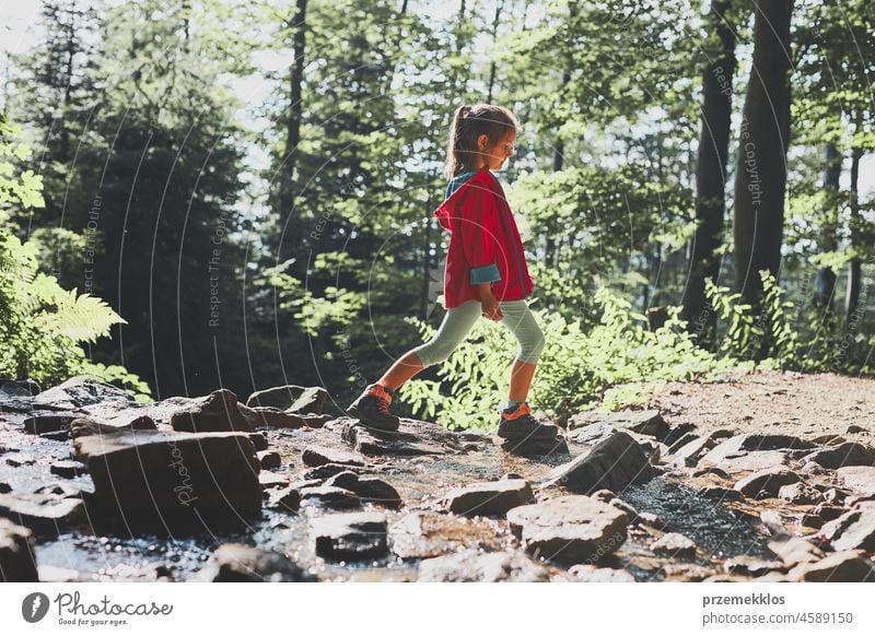 Little girl walking in mountains, spending summer vacation close to nature adventure trip travel hiking child kid trekking active backpack journey wanderlust