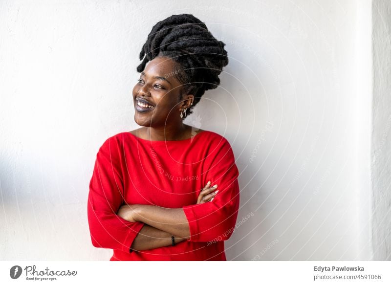 Portrait of a smiling young woman indoors black millennials hipster loft window natural adult one attractive successful people confident person beautiful female