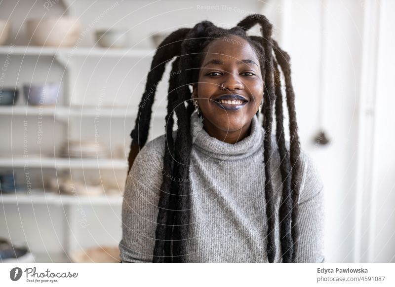 Confident female pottery artist in her art studio black millennials hipster indoors loft window natural adult one attractive successful people confident person