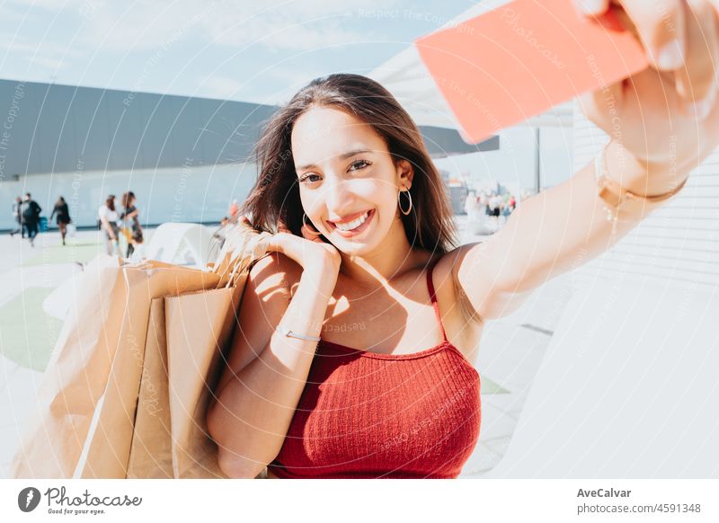 Young african woman holding a credit card blanck space shopping outdoors with copy space. Happy, trendy hipster girl ordering food online, booking tickets during a sunny day. Trendy young people